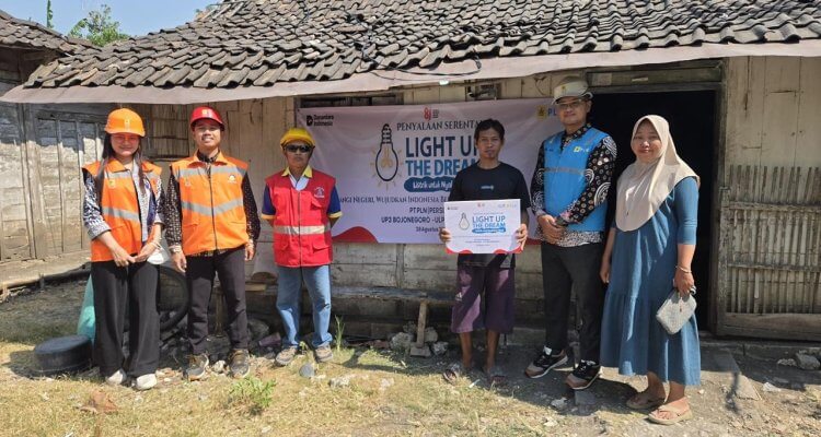 Petugas PLN UP3 Bojonegoro bersama salah satu penerima manfaat berfoto usai penyalaan serentak program Light Up The Dream di rumah warga kurang mampu.