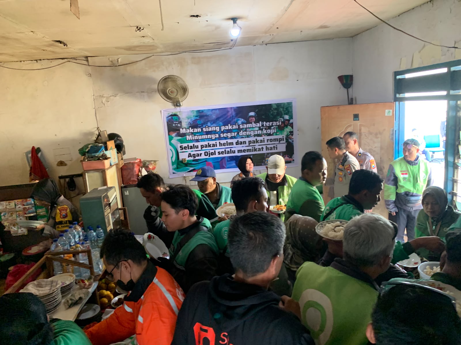 Suasana makan siang bersama jajaran Polres Bojonegoro dan lebih dari 100 pengemudi ojol di Warung Ojol Kamtibmas, Bojonegoro. 