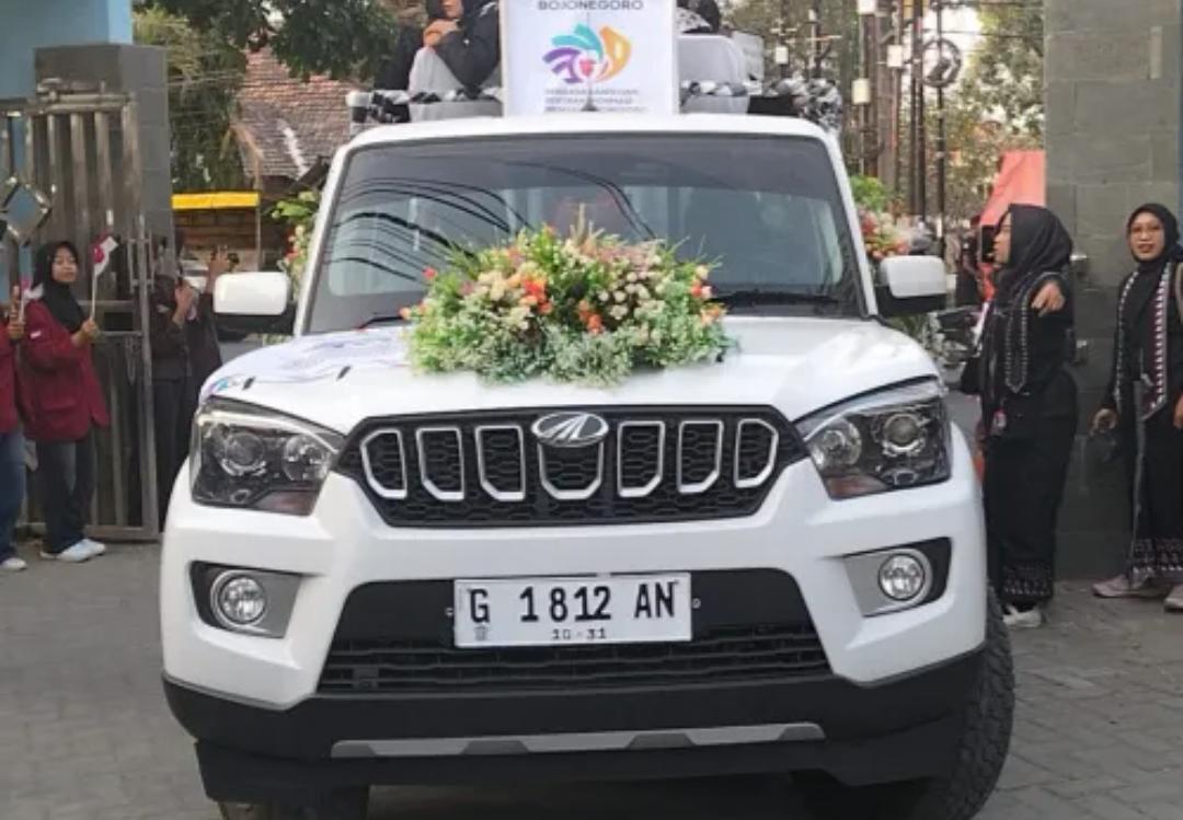Mobil berwarna putih dengan nomor polisi G 1812 AN yang terlihat dalam dokumentasi kirab Api Abadi HJB ke-349 di Bojonegoro.